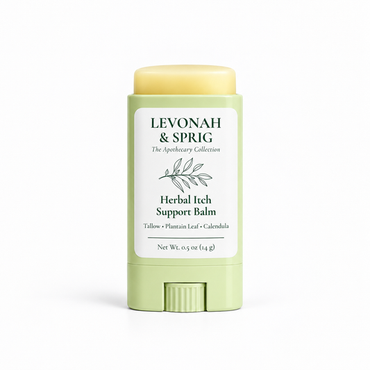 LEVONAH & SPRIG Herbal Itch Support Balm in an open, light sage-green twist-up tube, revealing the pale yellow balm above the container. The label features botanical artwork and highlights tallow, plantain leaf, and calendula.