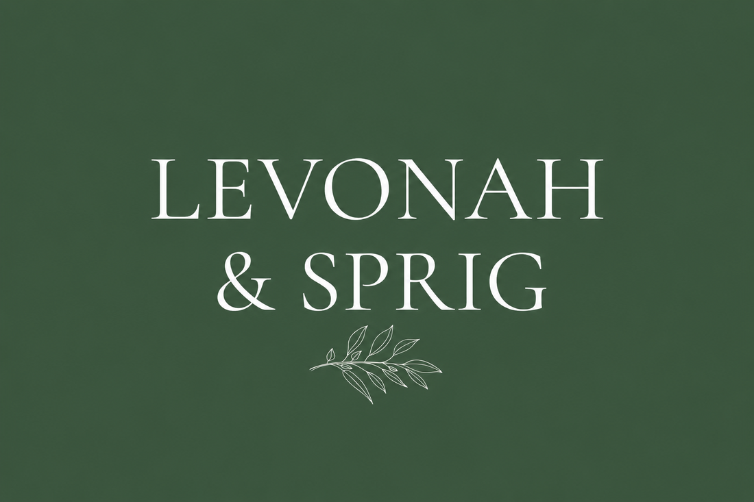 Levonah & Sprig wordmark with a sprig graphic on a cream font on a forest green background