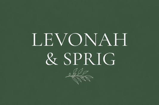 Levonah & Sprig wordmark with a sprig graphic on a cream font on a forest green background