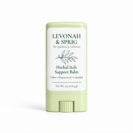 A stick container of Levonah & Sprig Herbal Itch Support Balm in a pale sage green color with a white label, shown on a clean white background.