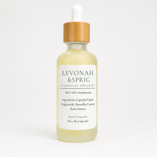 Levonah & Sprig Frankincense Infused Oil in a 2 fl oz frosted glass dropper bottle with a bamboo cap, featuring an MCT oil and frankincense formula, photographed on a clean white background.