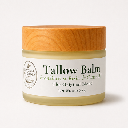 A jar of Levonah & Spring Tallow Balm with a light wood-grain lid and a white label, set against a clean white background.